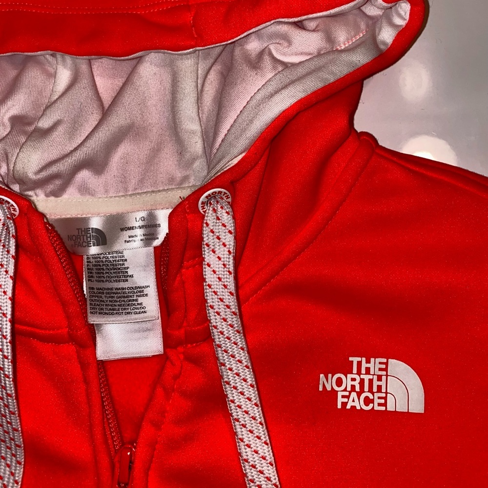 LG hoodie with slots for your thumbs. Color is a bright orange, pink shade.